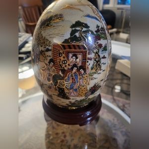 Chinese Porcelain Egg with wood base.